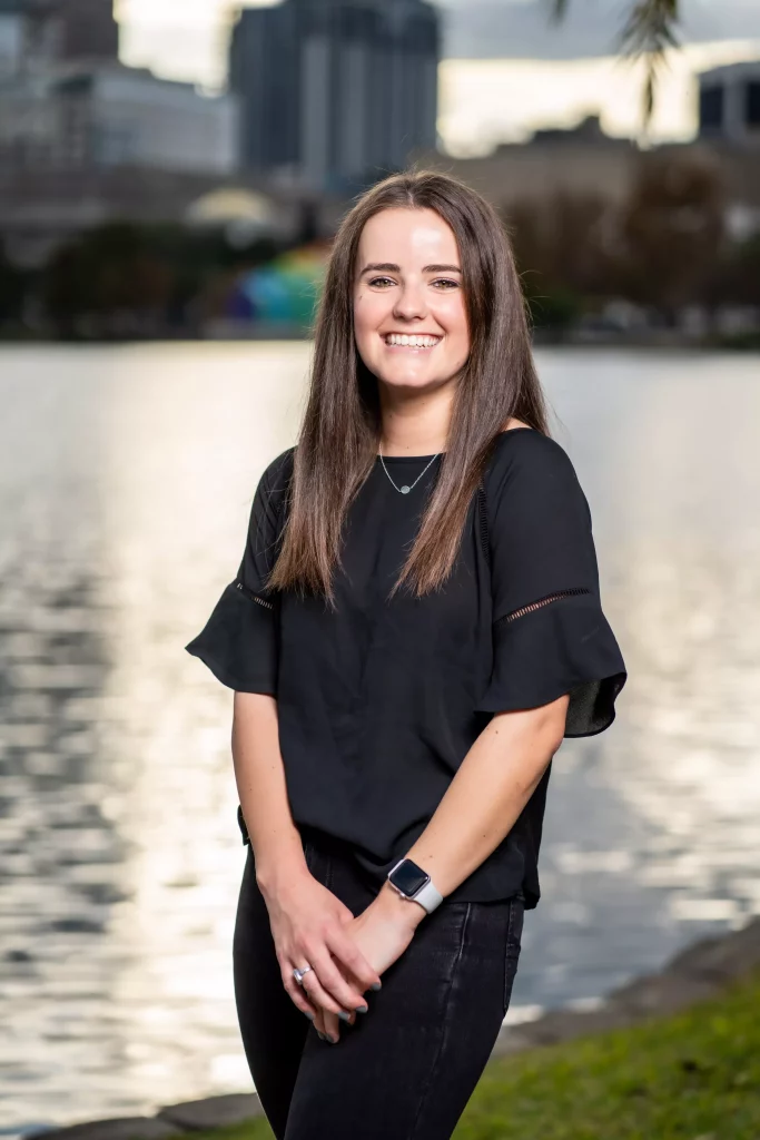 Smiling woman by water background.