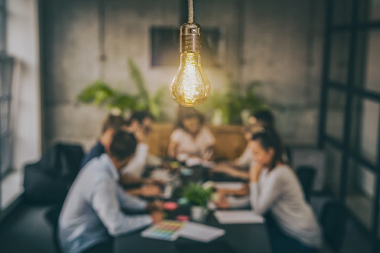 Bright light bulb over meeting table