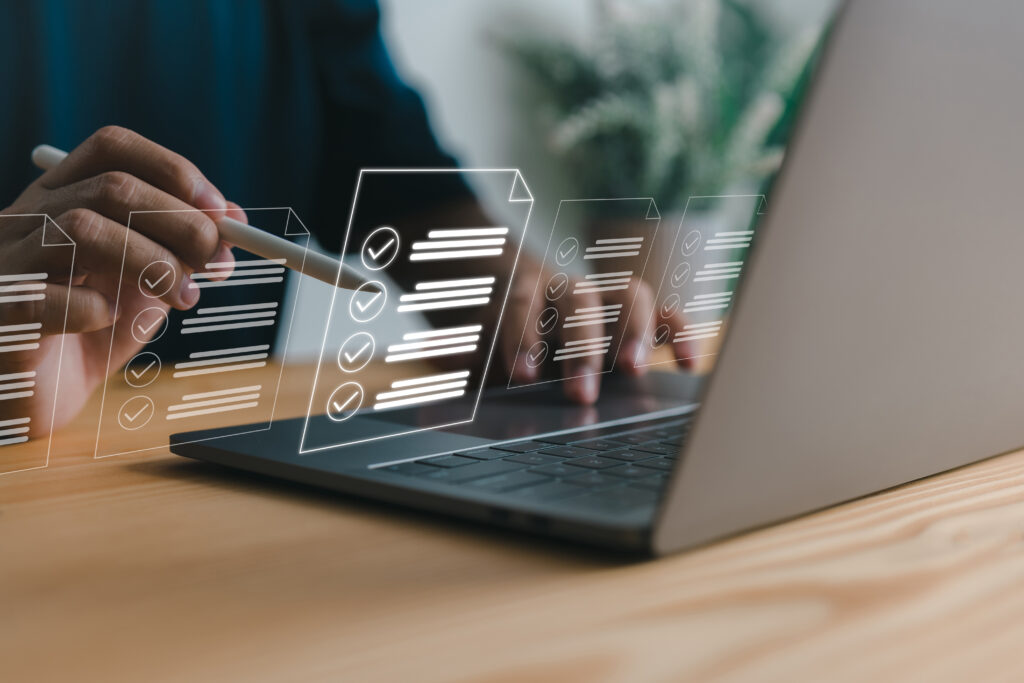 Person working on laptop with documents