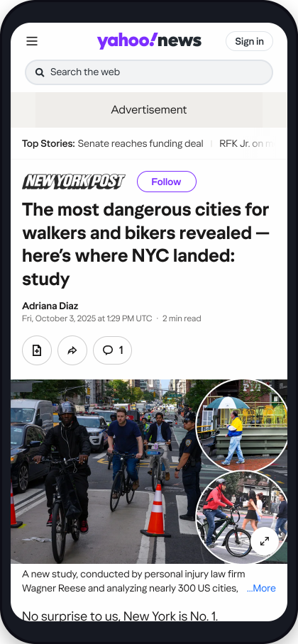 Phone showing a Yahoo News article citing a Wagner Reese study on the most dangerous cities for pedestrians and cyclists